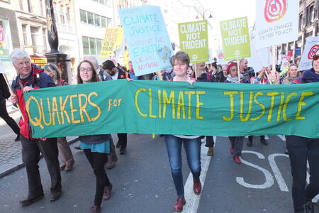 People marching under Quakers for Climate Justice banner