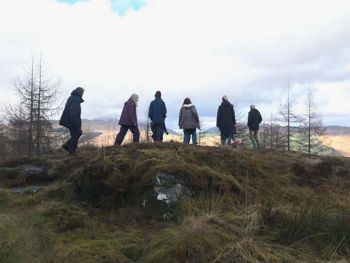 Friends looking out over stunning Scottish hills with snow on top