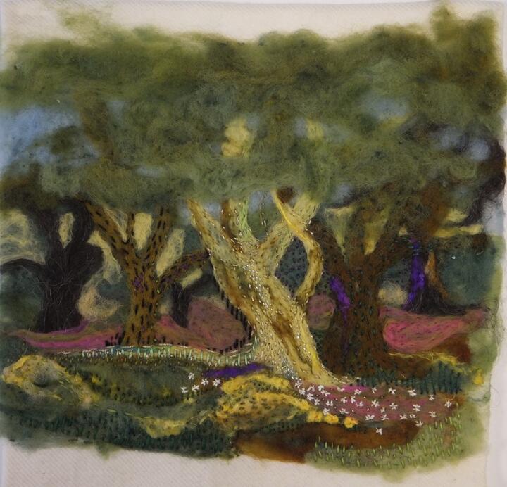 A delicately embroidered panel of trees and underbrush in muted greens and browns.