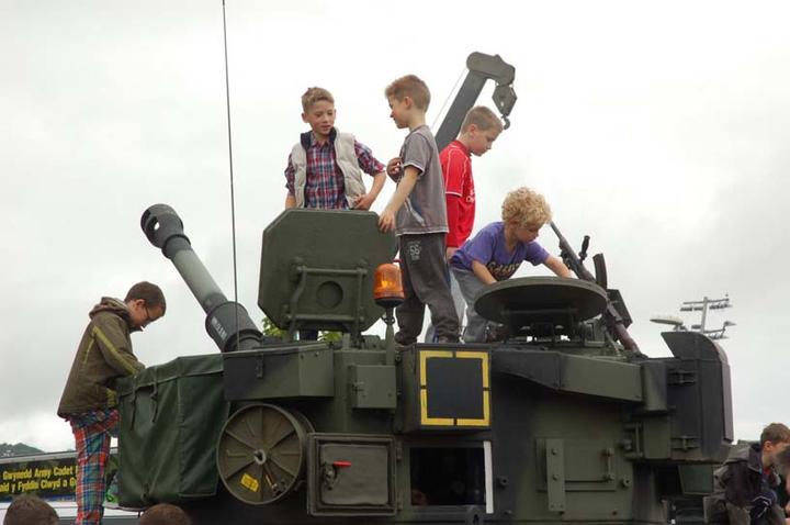 Ready for action: Children explore military tank
