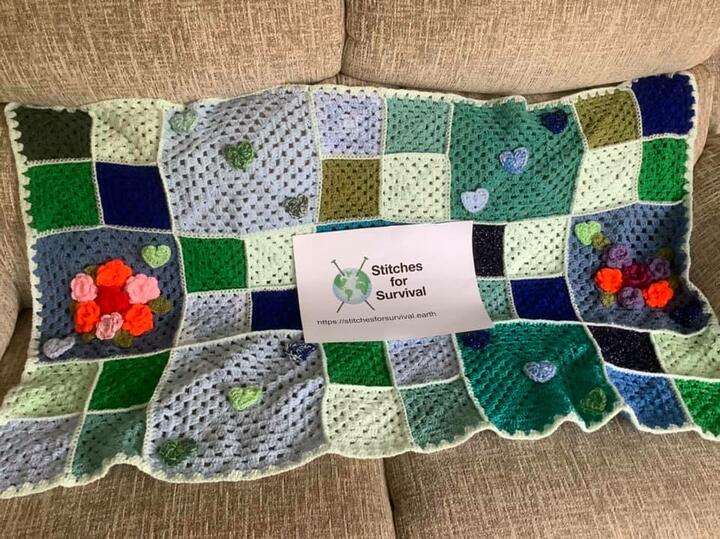 Stiches for survival from https://stitchesforsurvival.earth Crocheted blanket and stiches for survival logo