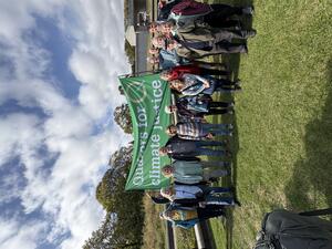 Several Quakers stand under a Quakers for Climate Justice banner outside the Scottish Parliament