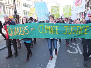 People marching under Quakers for Climate Justice banner