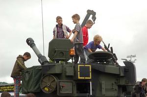 Ready for action: Children explore military tank